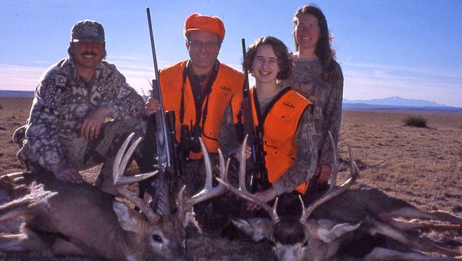 Patrick Durkin and his daughter Leah pose 73 miles from Colorado’s Pikes Peak, seen in the background, after hunting in December 2002 with Greg and Cindy Cox.