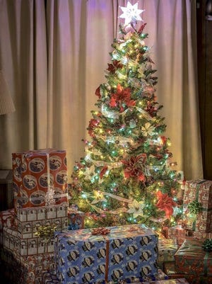 A Christmas tree can serve as the perfect holiday backdrop for friends and family to sit around and enjoy each other's company.
