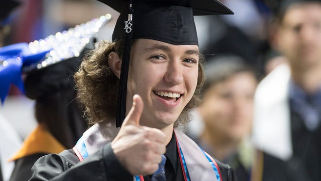 An MTSU student gives a happy thumbs-up Saturday, May 4, as he prepares to receive his diploma at the university’s spring 2018 undergraduate commencement morning ceremony in Murphy Center.