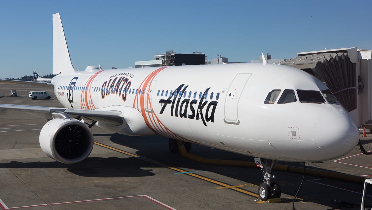 An Alaska Airlines Airbus A321 painted in the colors of the San Francisco Giants baseball team rests at a gate in Seattle-Tacoma International Airport in August 2018.