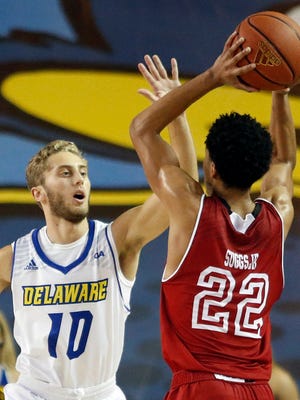 Delaware guard Curtis McRoy (left) defends against Bradley's Ronnie Suggs in the second half of Delaware's 70-47 win at the Bob Carpenter Center.