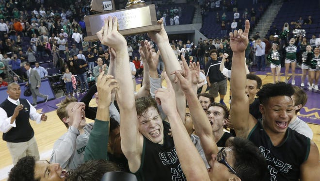 Sunnyslope's Chris Orozco (22) lifts the trophy with his team celebrating the State Championship win over Apollo, 58-57 in double overtime, at GCU Arena on February 27, 2017 in Phoenix, Ariz.