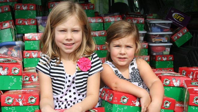 Peyton Mead, 5, and her sister, Emma, 3, helped collect 50 boxes filled with toys and supplies for kids in need.