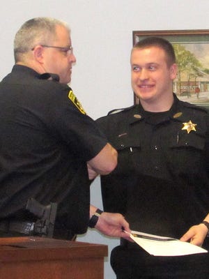 Chemung County Undersheriff William Schrom, left, congratulates correction officer Andrew Zobel on Friday for completing a training course.