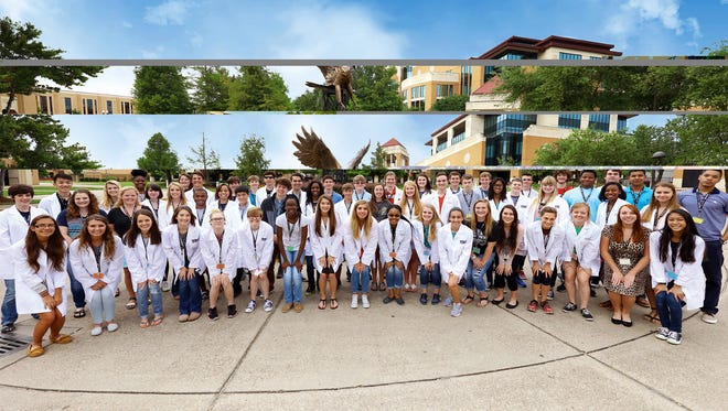 High school students participating in a University sof Louisiana Monroe President’s Academy gather in Scott Plaza for a group photo.