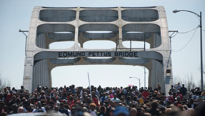 People gather on the Edmund Pettus Bridge in Selma, Ala., on Sunday, March 8, 2015, for a march to commemorate the 50th anniversary of Bloody Sunday.