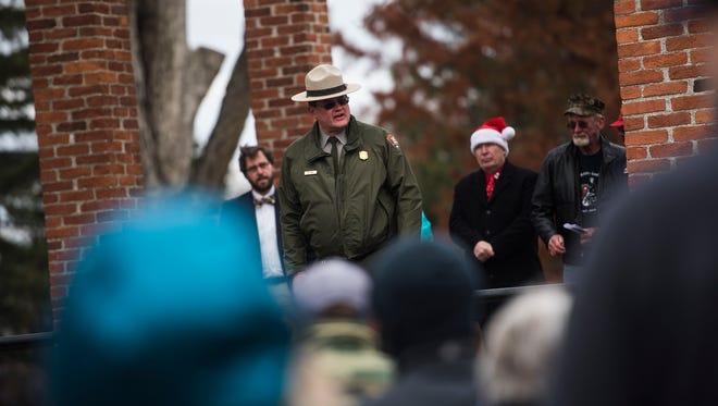 Gettysburg National Military Park superintendent Ed Clark speaks to a crowd before volunteers prepare to lay Christmas wreaths on graves at Soldiers' National Cemetery in Gettysburg on Friday Dec. 2, 2016.