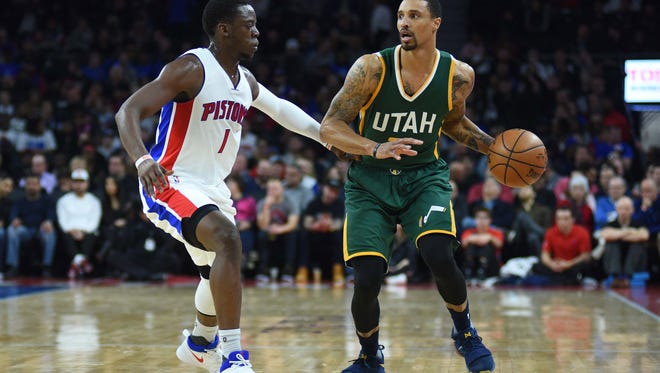 Jazz guard George Hill (3) controls the ball against Pistons guard Reggie Jackson (1) during the second quarter of the Pistons' loss Wednesday at the Palace.