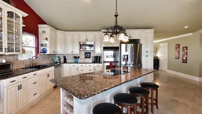 5156 Point Shores Lane; the open kitchen includes bar seating.