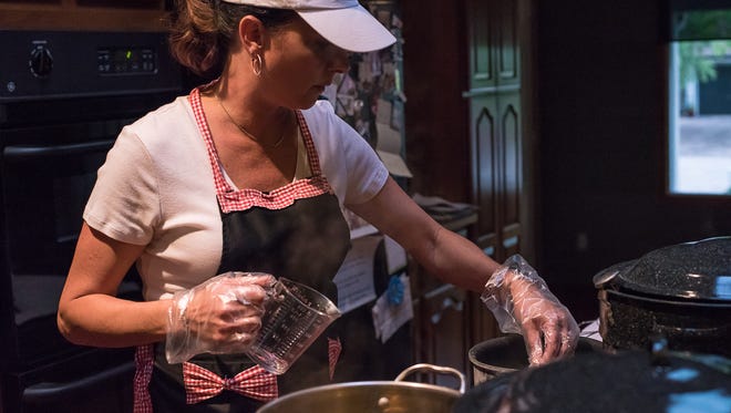 Mykel Brawley, owner of the Fort Collins Pickle Company, prepares brine on the stovetop in her home kitchen on Thursday, August 10, 2017.