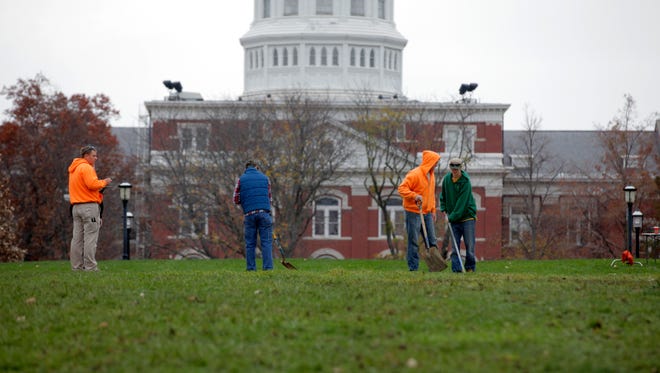 University of Missouri grounds maintenance workers begin to clean up Mel Carnahan Quad on the University of Missouri campus Wednesday, Nov.11, 2015, in Columbia, Mo.
