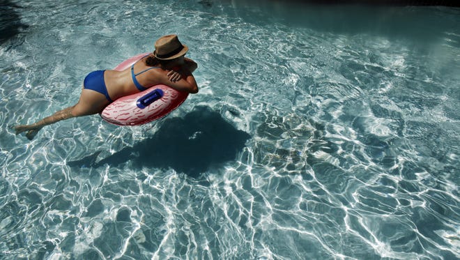 Dinah Irwin enjoys adult swim time at City Park Pool Thursday June 5, 2014.