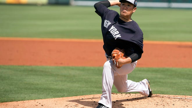 New York Yankees starting pitcher Masahiro Tanaka pitches against the Pittsburgh Pirates during the first inning at McKechnie Field Thursday in Bradenton, Florida. Comcast has dropped the YES Network, which carries most Yankees games, from its lineup.
