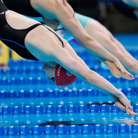 Katie Ledecky dives off the starting block during 