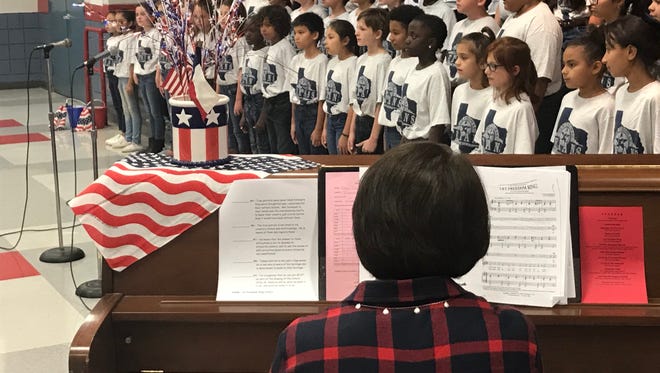 Thomas Elementary's Thomas Texans Singers, a group of select fourth and fifth grade student singers, perform with piano accompanist Kelley Clay during a special Veterans Day program Thursday, Nov. 9, 2017.