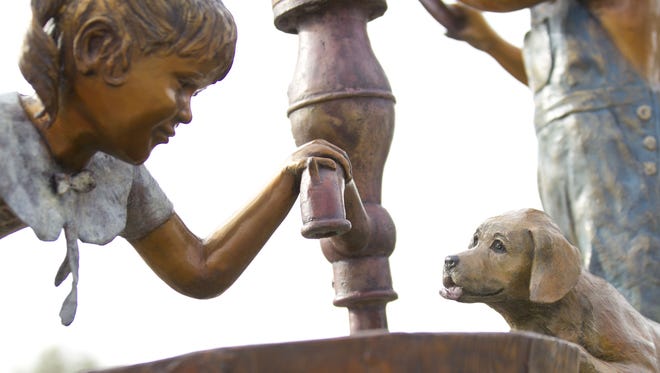 Puppy Love is a public art sculpture at Johnny E. Osuna Memorial Park in Peoria, AZ.