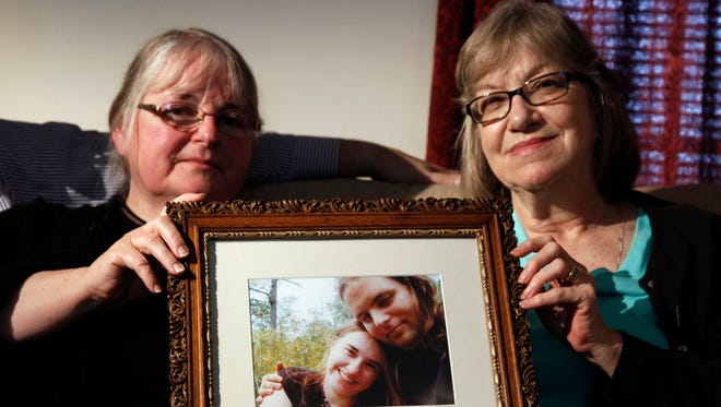 FILE- In this June 4, 2014, file photo, mothers Linda Boyle, left and Lyn Coleman hold photo of their married children, Joshua Boyle and Caitlan Coleman, who were kidnapped by the Taliban in late 2012 in Stewartstown, Pa. The State Department is evaluating a video released by the Afghan Taliban showing Joshua Boyle and Caitlan Coleman warning that their Afghan captors will kill them unless the Kabul government ends its executions of Taliban prisoners. State Department spokesman John Kirby said at his daily briefing Tuesday, Aug. 30, 2016, that the video purportedly showing the couple is “being examined for its validity.”