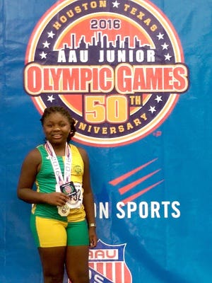 Ayanna Hunt, of Anderson, is at the podium where she accepted her gold medal in shot put, in Houston.