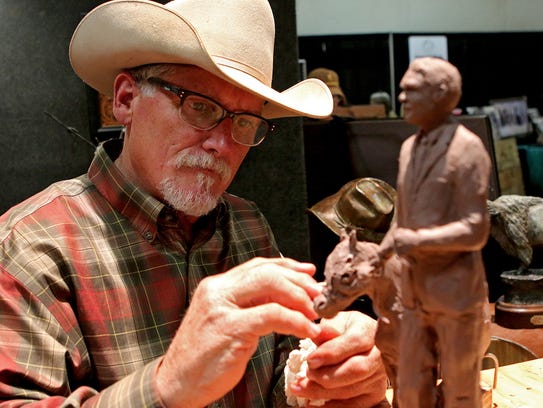 Artist John Rule works on a model for a sculpture he's