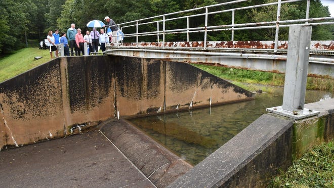 FILE - In this Sept. 28, 2019, file photo, officials look at damage to Heller Dam at Hagerman's Reservoir near South Williamsport, Pa. Pennsylvanians who live downstream from its many dams may not often think about what could happen, but inspectors know there are potential threats to life and property along the state's 86,000 miles of streams and rivers. (Mark Nance/Sun-Gazette via AP)