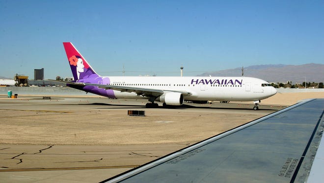 Officials say a Hawaiian Airlines flight from Honolulu to New York City was diverted to San Francisco after an attendant died of an apparent heart attack.
