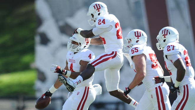 FILE -- Indiana's LB Forisse "Flo"  Hardin (4) celebrates an interception with Tim Bennett (24)  during the 2013 Indiana University Spring Football at Memorial Stadium in Bloomington.