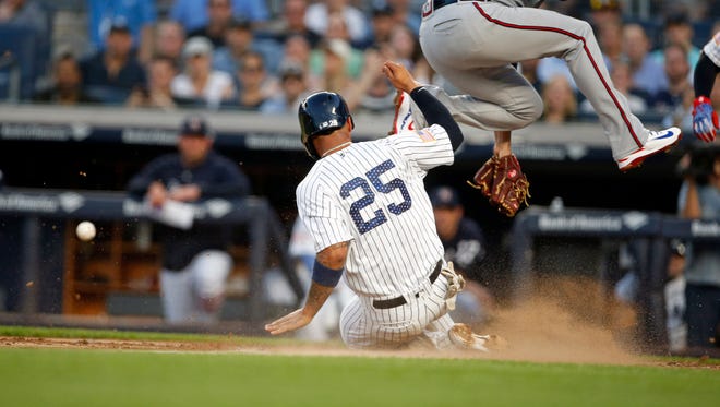 New York Yankees second baseman Gleyber Torres (25) scores a run on wild pitch.