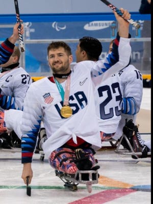 Travis Dodson celebrated his team gold medal with the U.S. Paralympic Sled Hockey Team in PyeongChang, South Korea..