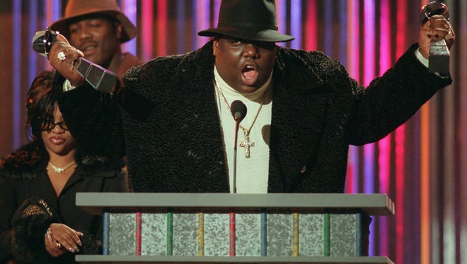 FILE--Notorious B.I.G., winner of rap artist and rap single of the year, clutches his awards at the podium during the annual Billboard Music Awards in New York Wednesday evening, Dec. 6, 1995. The rapper, whose real name was Christopher Wallace, was gunned down in Los Angeles as he left a party early Sunday, March 9, 1997, police said. Wallace, 24, was reportedly attending a party at the Petersen Automotive Museum in celebration of Friday s 11th Annual Soul Train Music Awards. (AP Photo/Mark Lennihan, File) ORG XMIT: NY107