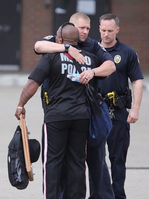 LMPD officers embrace outside of University of Louisville Hospital where a fellow officer is hospitalized after a Tuesday night crash. 
March 29, 2017