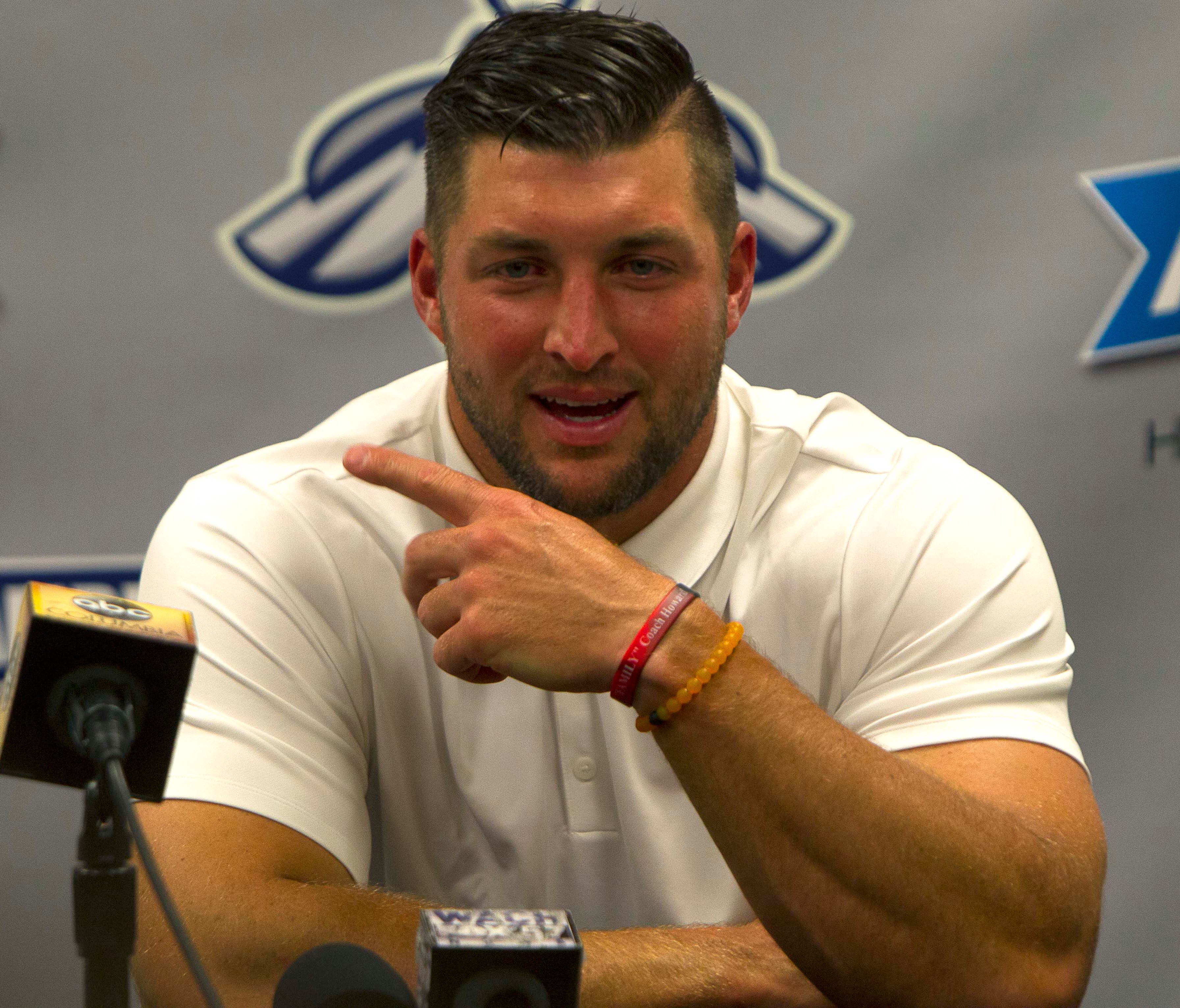 Tim Tebow answers questions during a press conference after the game.