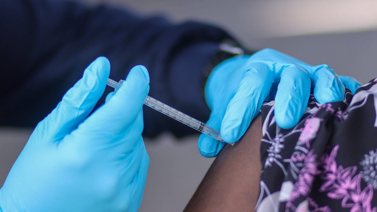 Palm Beach County firefighter Nelson Ramirez administers a Covid-19 vaccination to a woman in Lantana, Florida, on July 28. The vaccinations were being organized by the Health Care District of Palm Beach County.