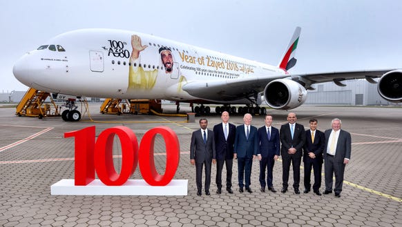 Emirates and Airbus officials pose with Emirates airline's