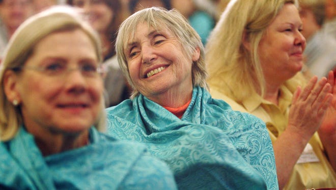 Maggie Mellor (center) hugs herself as part of a self-affirmation exercise during  a 2016 caregiver recognition event hosted by Senior Concerns in Thousand Oaks.