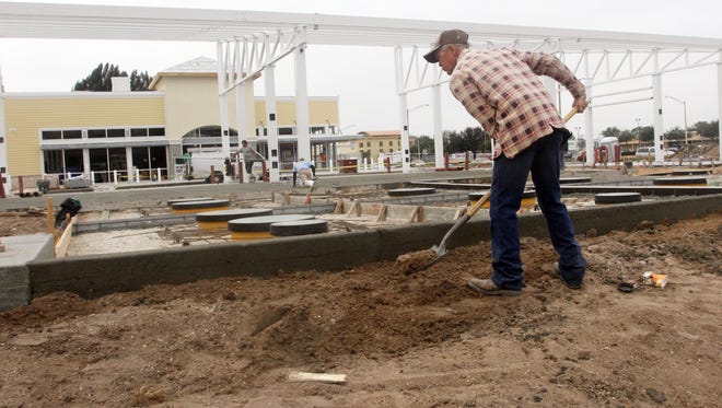 FILE: Derek Pfister does some shovel work around the gas tanks at the new WAWA service station at the corner of Del Prado and Pine Island Road Thursday morning in Cape Coral.