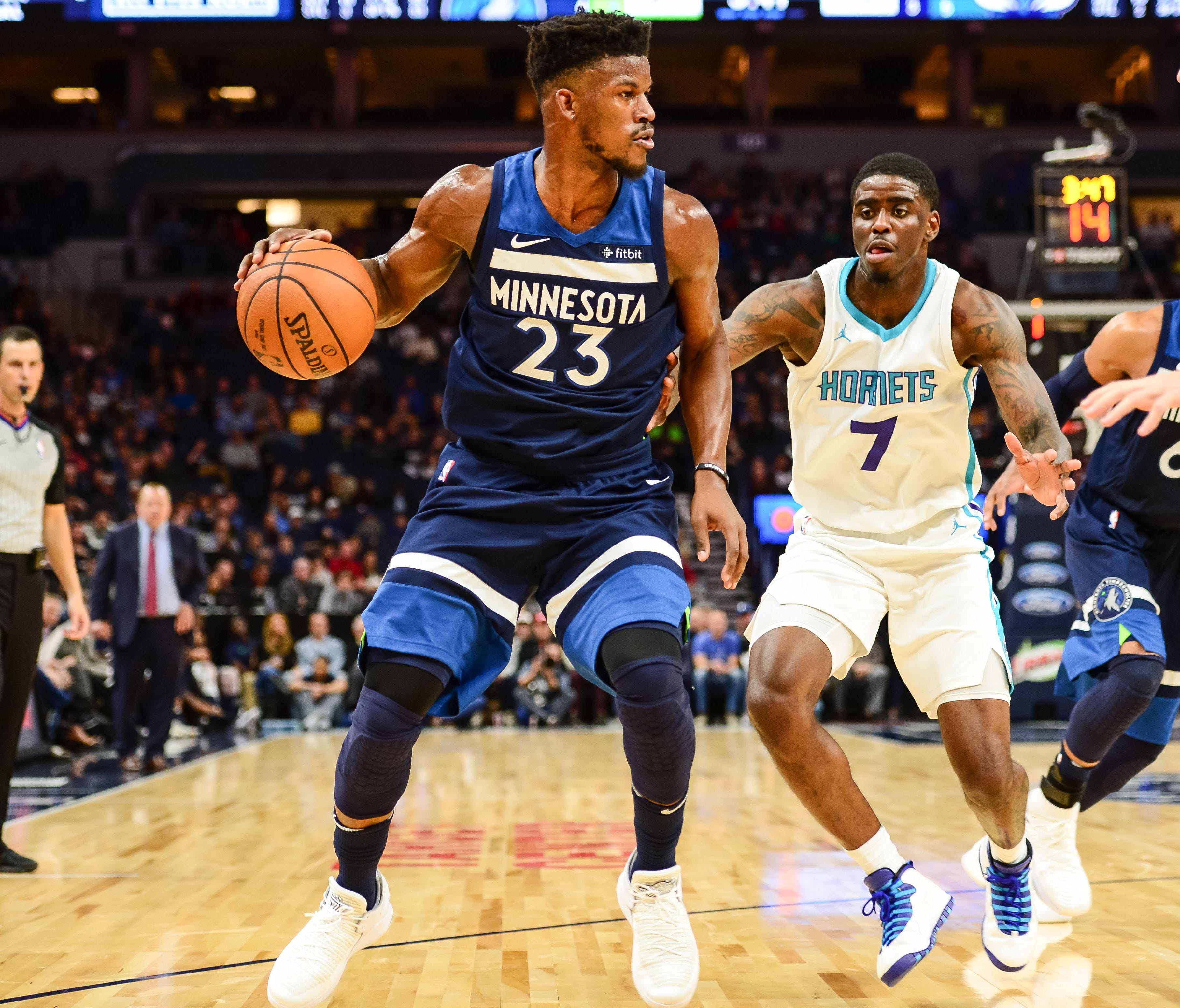 Minnesota Timberwolves guard Jimmy Butler (23) controls the ball while defended by Charlotte Hornets forward Dwayne Bacon (7) during the third quarter at Target Center. The Timberwolves won 112-94.