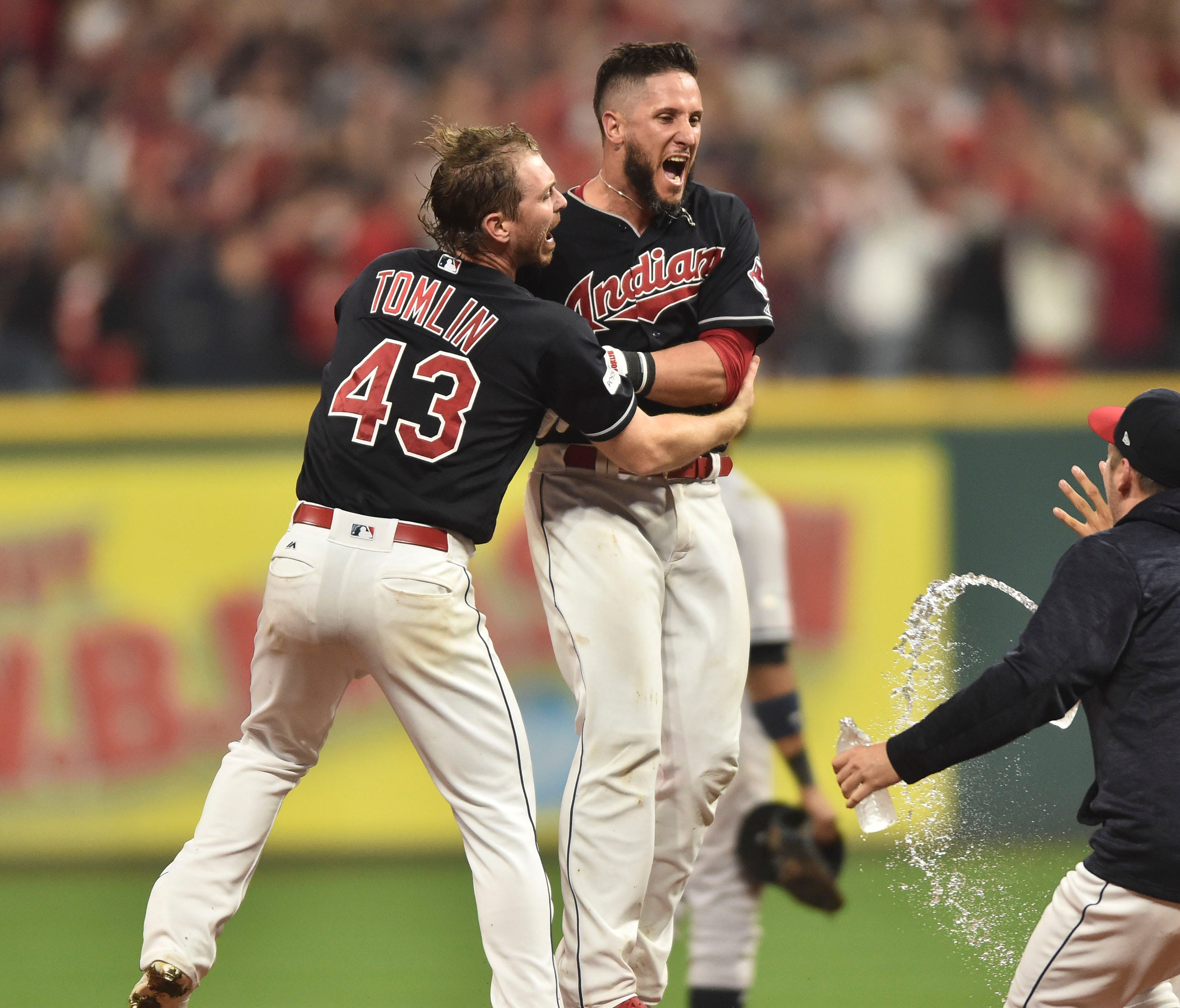 Yan Gomes is congratulated by Josh Tomlin and his teammates after Gomes' walk-off single.
