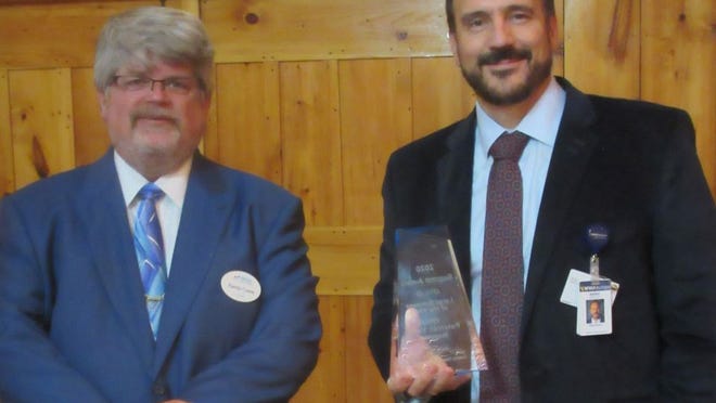 WVU Potomac Valley Hospital CEO Mark Boucot (right) accepts the Mineral County Chamber of Commerce Large Business of the Year Award from Chamber president Randy Crane during this week's Summit Awards.
Tribune photo by Ronda Wertman