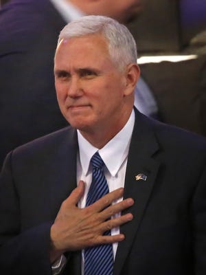 Then Vice President-elect Mike Pence acknowledges the crowd before the swearing in of new Indiana Gov. Eric Holcomb on Jan. 9 at the Indiana State Fairgrounds.
