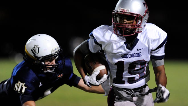 Park Crossing's Jahad Booker (19) runs with a reception against St. James' Frank Woodson (4) on Friday September 26,  2014 at the St. James campus in Montgomery, Ala.