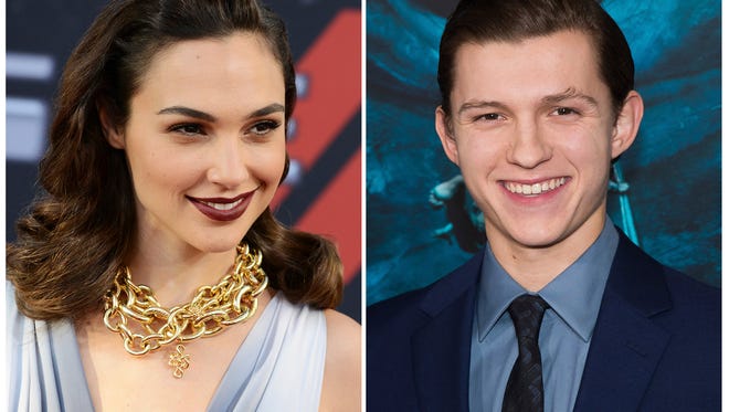 In this combination photo, Gal Gadot arrives at the premiere of the "Fast & Furious 6" on May 21, 2013 in Universal City, Calif., left, and Tom Holland attends the premiere of "In the Heart of the Sea" on Dec. 7, 2015, in New York. Gadot stars in "Wonder Woman", in theaters on June 2 and Holland stars in "Spider-Man: Homecoming," in theaters on July 15.  (Photo by Jordan Strauss, left, and Charles Sykes/Invision/AP, File)