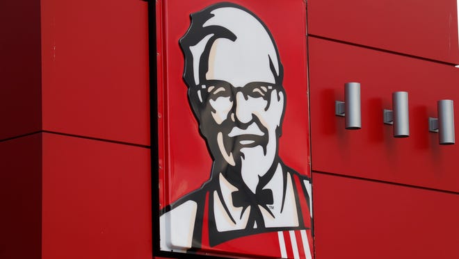 In this Tuesday, Oct. 9, 2012, file photo, a close-up of a sign with a picture of Colonel Sanders is shown on the wall of a combination Kentucky Fried Chicken, Taco Bell in Doral, Fla. KFC said it will start delivering its buckets of fried chicken to customers in Los Angeles and San Francisco, beginning Thursday, Nov. 12, 2015. It's the first time the chicken chain has delivered in the United States.