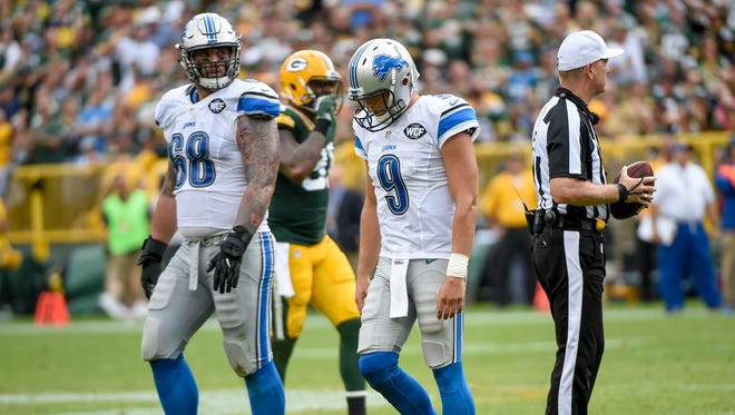 Sep 25, 2016; Green Bay, WI, USA;  Detroit Lions quarterback Matthew Stafford and offensive lineman Taylor Decker walk back to the bench after being sacked in the fourth quarter during the game against the Green Bay Packers at Lambeau Field.
