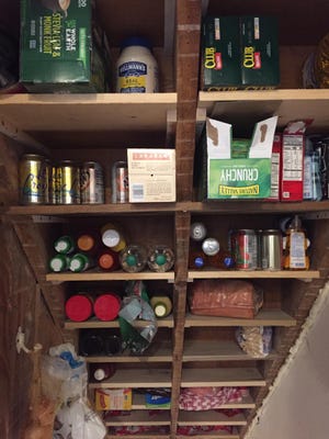 Annette Kuss of Bexley said her husband, Steve, and son, Andy, have done a couple of stay-at-home projects she has wanted for years, including this basement stairway pantry.
