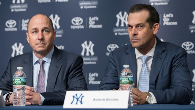 Yankees GM Brian Cashman (left) will now work on making sure his new manager Aaron Boone has as much talent as possible.