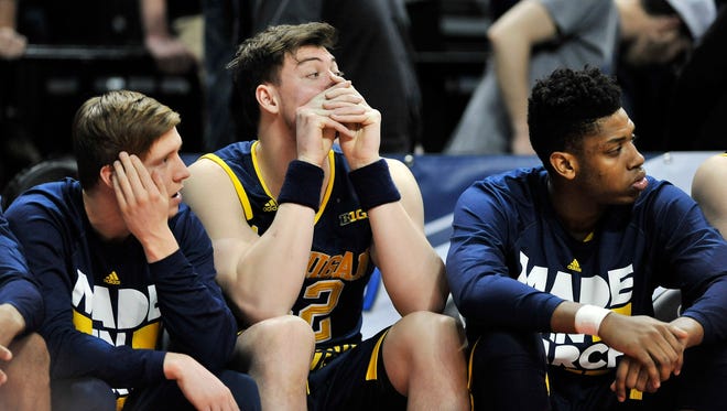 From left, Michigan guard Spike Albrecht, Ricky Doyle and Kameron Chatman watch while Michigan trails Notre Dame in the second half.