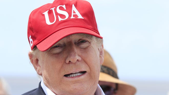 President Donald Trump speaks to reporters during a visit to Lake Okeechobee and Herbert Hoover Dike at Canal Point, Fla., Friday, March 29, 2019.