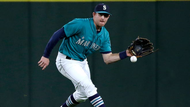 Seattle Mariners' Brad Miller fields a ball during a baseball game against the Oakland Athletics in Seattle. The Mariners and the Tampa Bay Rays have completed the first significant trade of the offseason, a six-player swap that sends Miller, first baseman Logan Morrison and pitcher Danny Farquhar to Tampa Bay for pitchers Nathan Karns and C.J. Riefenhauser, and minor league outfielder Boog Powell. The teams announced the deal Thursday night, Nov. 5.