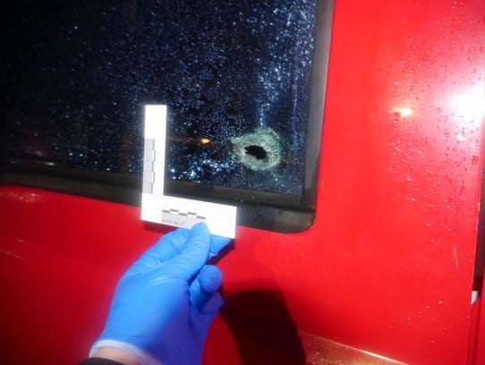 The bullet hole in a truck at Grove Park Apartments