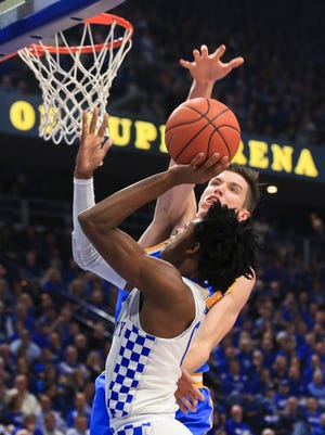 UCLA's Thomas Welsh blocks Kentucky's De'Aaron Fox in the first half in the Bruins' upset win over the Wildcats 97-92 Saturday afternoon at Rupp Arena.